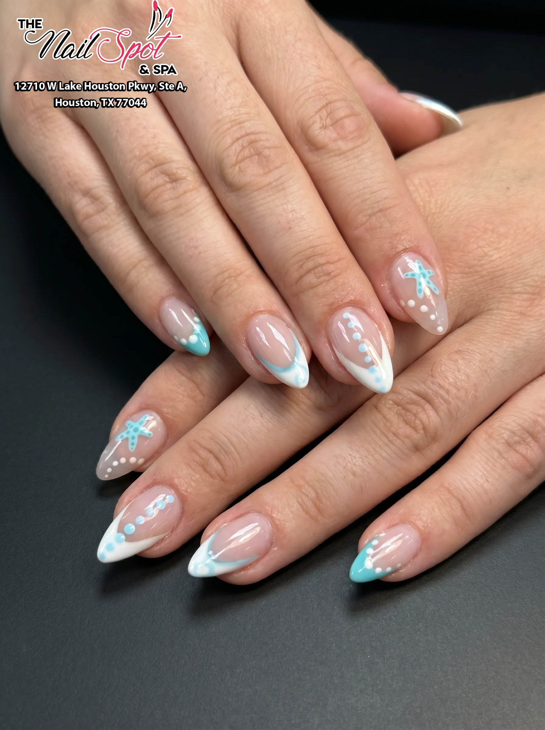 Blue and white nail art by The Nailspot & Spa